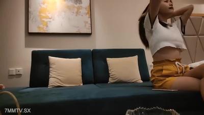 The skinny man chats and flirts on the sofa in various poses on the sofa in the open room of the hotel